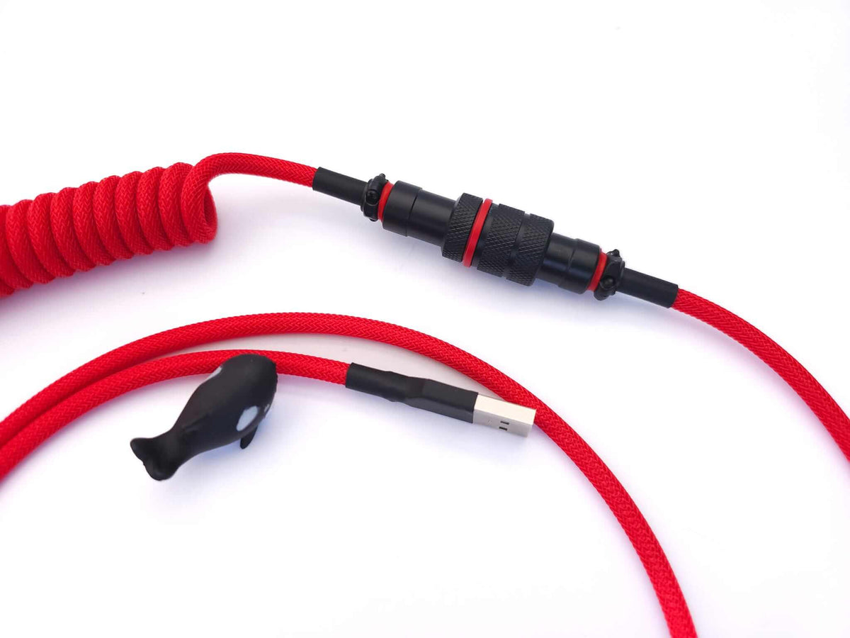 Black Gx16 Aviator Cable connector on red coil cable