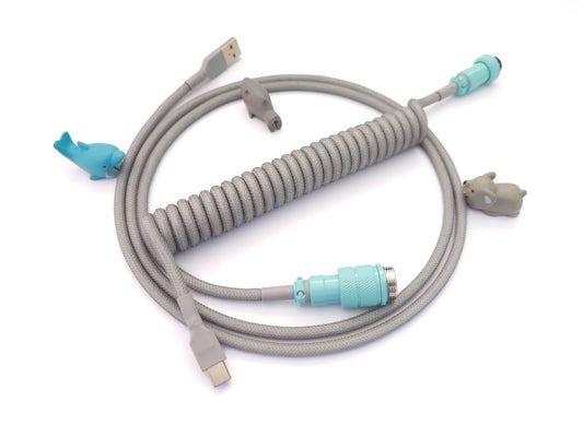 Coiled keyboard cable designed for GMK CYR Jags keycaps with grey coil and teal Gx16 aviator