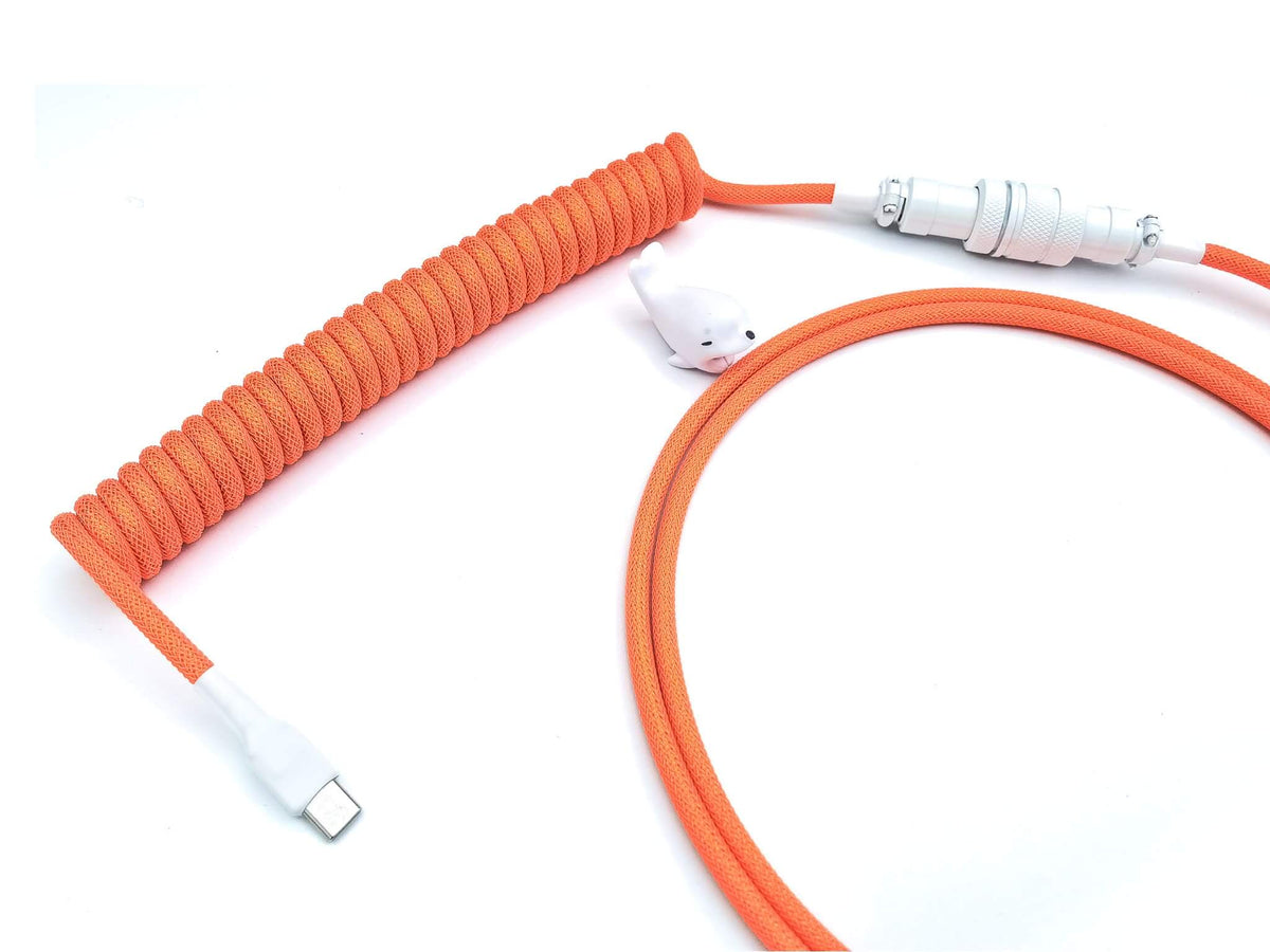 Neon Orange coiled cable for GMK Yuri keycaps with white Aviator connector and white cable bite protector