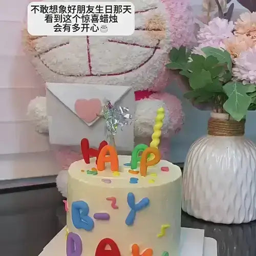 Colorful birthday cake with playful letters, candle, and cheerful decorations, celebrating a happy occasion.