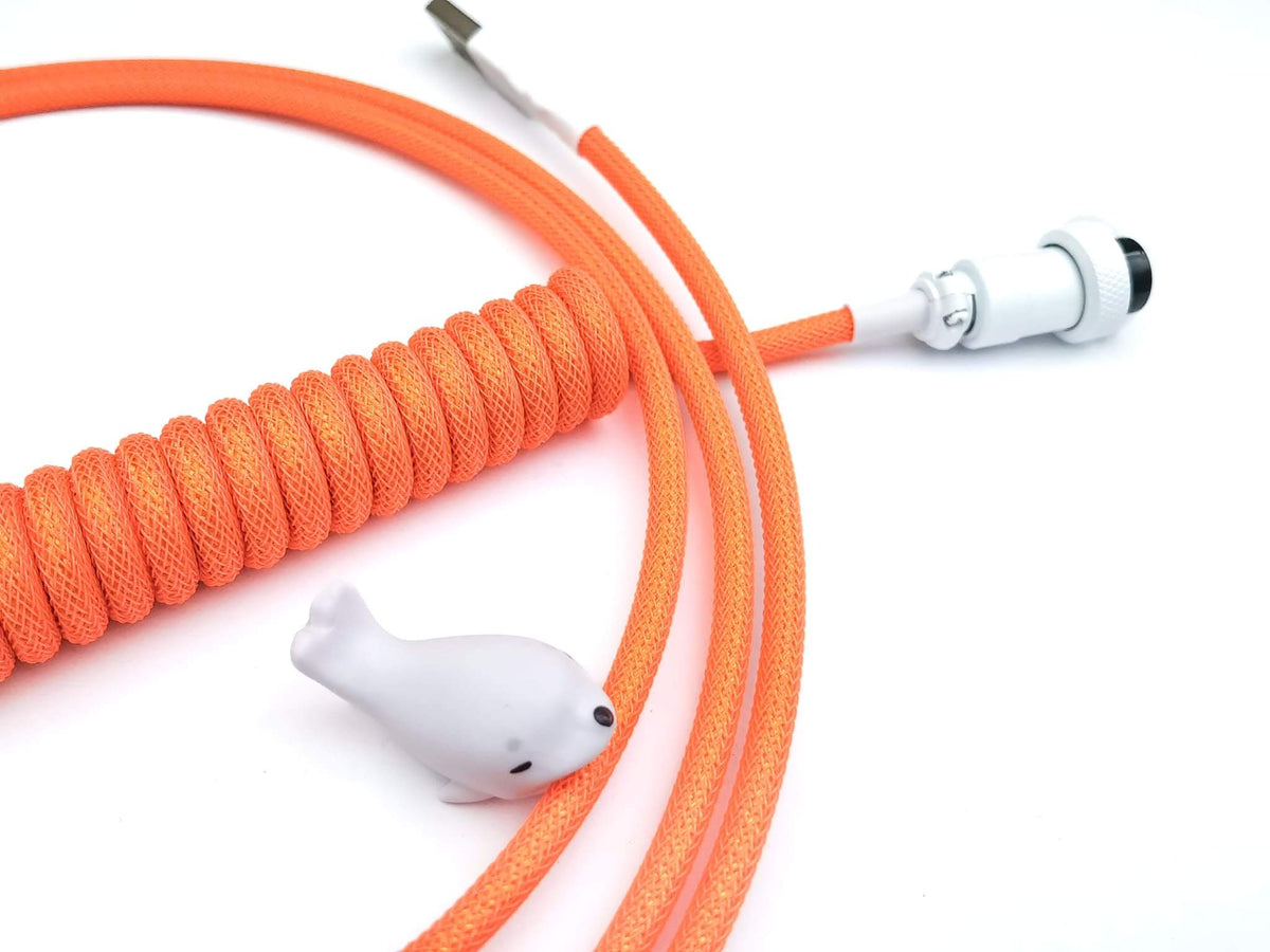 Orange coiled keyboard cable wtih Aviator connector and white cable bite protector